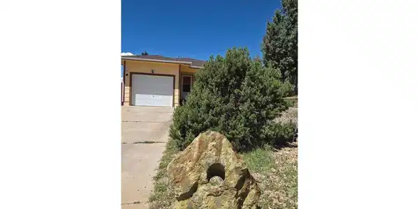 Image 2: Historic mining relic from the Cripple Creek/Victor district adds character to the front yard. Image 2: Historic mining relic from the Cripple Creek/Victor district adds character to the front yard.