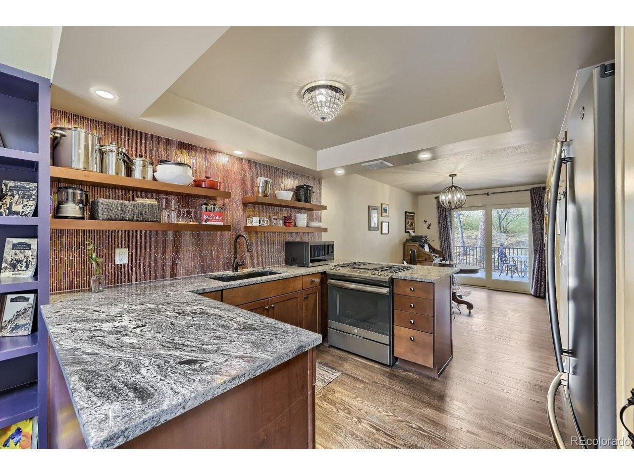 Image 2: Granite counters, pantry, glass blacksplash, gas range. Image 2: Granite counters, pantry, glass blacksplash, gas range.