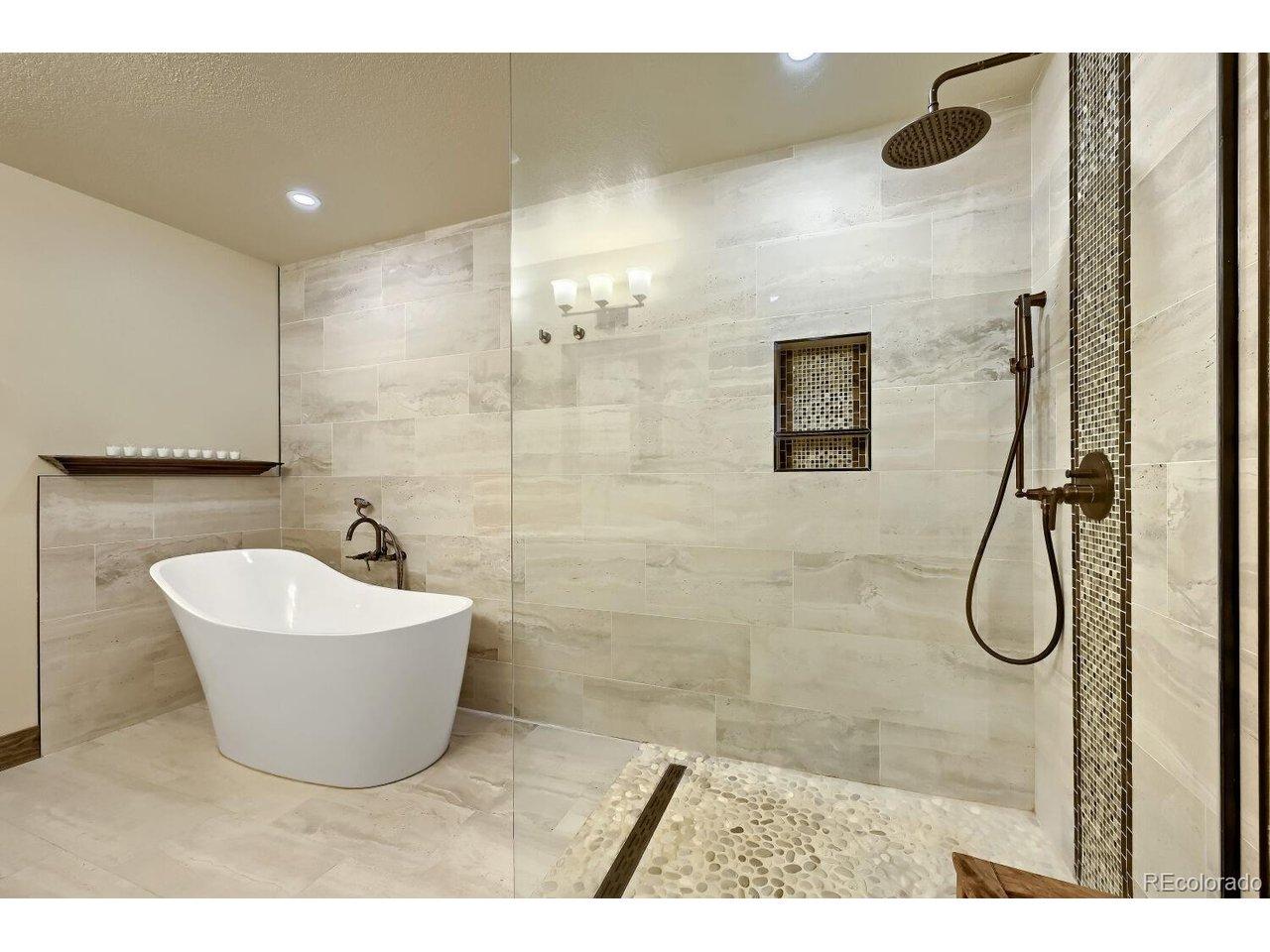 Image 3: Primary bathroom with heated floors, soaking tub, and shower. Image 3: Primary bathroom with heated floors, soaking tub, and shower.