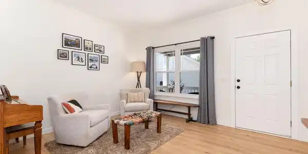 Image 4: Welcome inside! The versatile front living room is accented by engineered hardwood flooring that extends throughout the main level. Image 4: Welcome inside! The versatile front living room is accented by engineered hardwood flooring that extends throughout the main level.