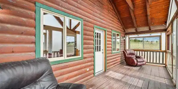 Image 3: Front enclosed porch area looking west Image 3: Front enclosed porch area looking west