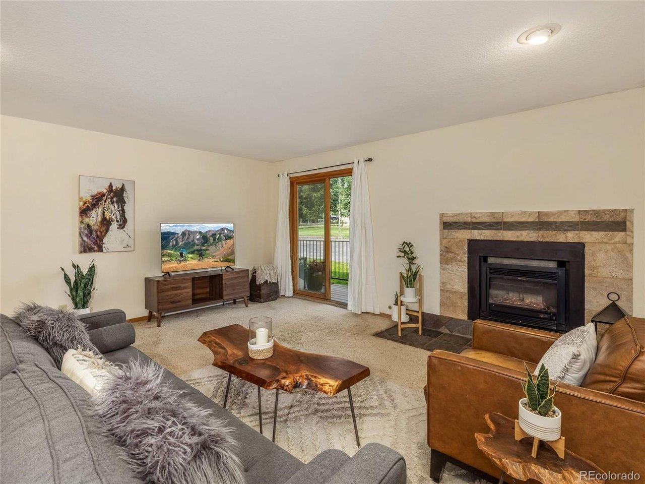 Image 1: Great room with fireplace. Sliding doors to the deck and access to outside