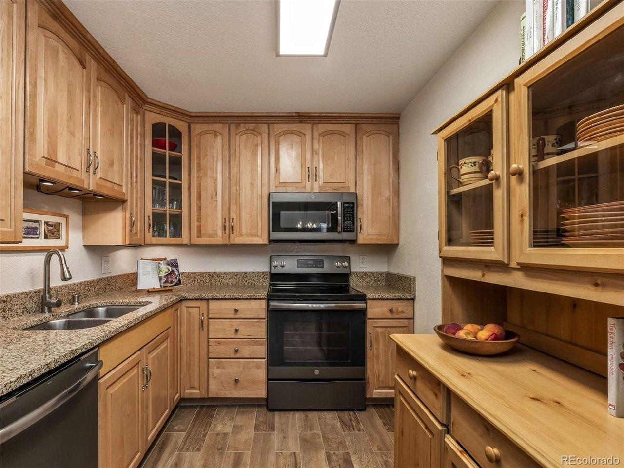 Image 4: Updated kitchen with maple cabinets and new floor