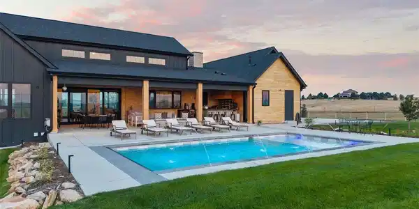 Image 2: Sparkling saltwater pool, gas fire pit, and covered patio with outdoor kitchen and bath, surrounded by nearly an acre of fenced, professionally landscaped grounds. Image 2: Sparkling saltwater pool, gas fire pit, and covered patio with outdoor kitchen and bath, surrounded by nearly an acre of fenced, professionally landscaped grounds.