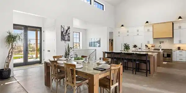 Image 3: Inside, honed concrete floors ground a soaring, 20-foot vaulted great room. Image 3: Inside, honed concrete floors ground a soaring, 20-foot vaulted great room.