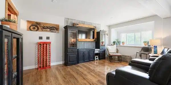 Image 3: A bright and spacious living room features gleaming wood floors, abundant natural light, and an open layout ideal for relaxing or entertaining. Image 3: A bright and spacious living room features gleaming wood floors, abundant natural light, and an open layout ideal for relaxing or entertaining.