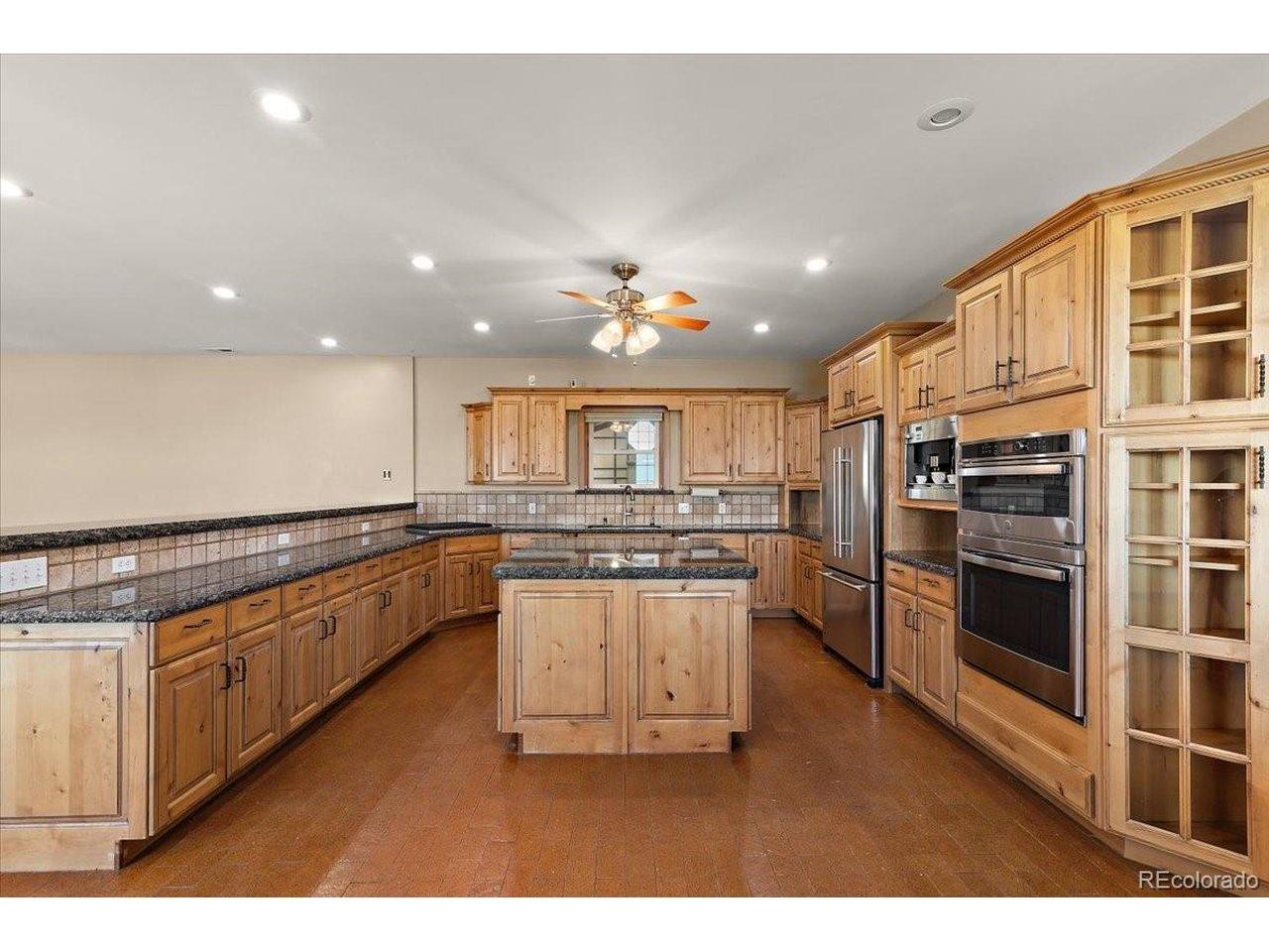 Image 3: Granite countertops surfaces on cabinets and Island, stovetop, microwave and oven are all new in 2026. Refrigerator and dishwasher are also included but age is unknown. lots of storage cabinets and breakfast bar area.