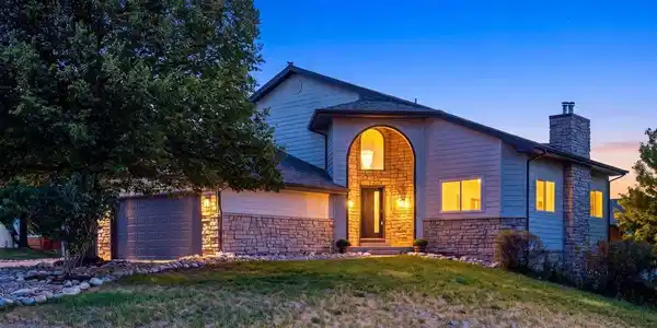 Image 2: Beautiful twilight exterior showcasing the home's striking stone accents, welcoming two-story entry, mature landscaping, and warm architectural lighting. Image 2: Beautiful twilight exterior showcasing the home's striking stone accents, welcoming two-story entry, mature landscaping, and warm architectural lighting.