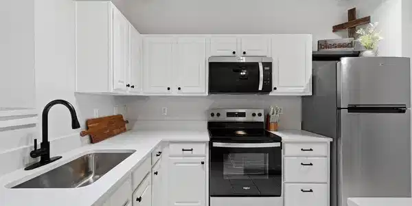 Image 4: New appliances and quartz counters were added in 2025 for a sizable and modern kitchen with a large pantry.