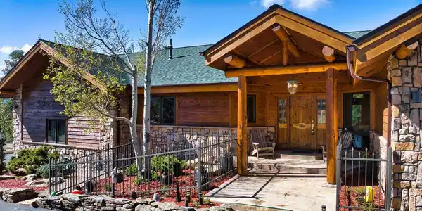 Image 2: Grand covered entry welcomes you with handcrafted timber details and timeless Colorado lodge design. Image 2: Grand covered entry welcomes you with handcrafted timber details and timeless Colorado lodge design.