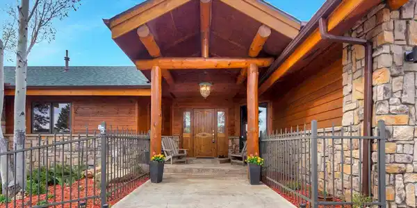 Image 3: Stunning custom mountain estate in The Reserve featuring timeless log and stone craftsmanship with a warm, welcoming entrance. Image 3: Stunning custom mountain estate in The Reserve featuring timeless log and stone craftsmanship with a warm, welcoming entrance.