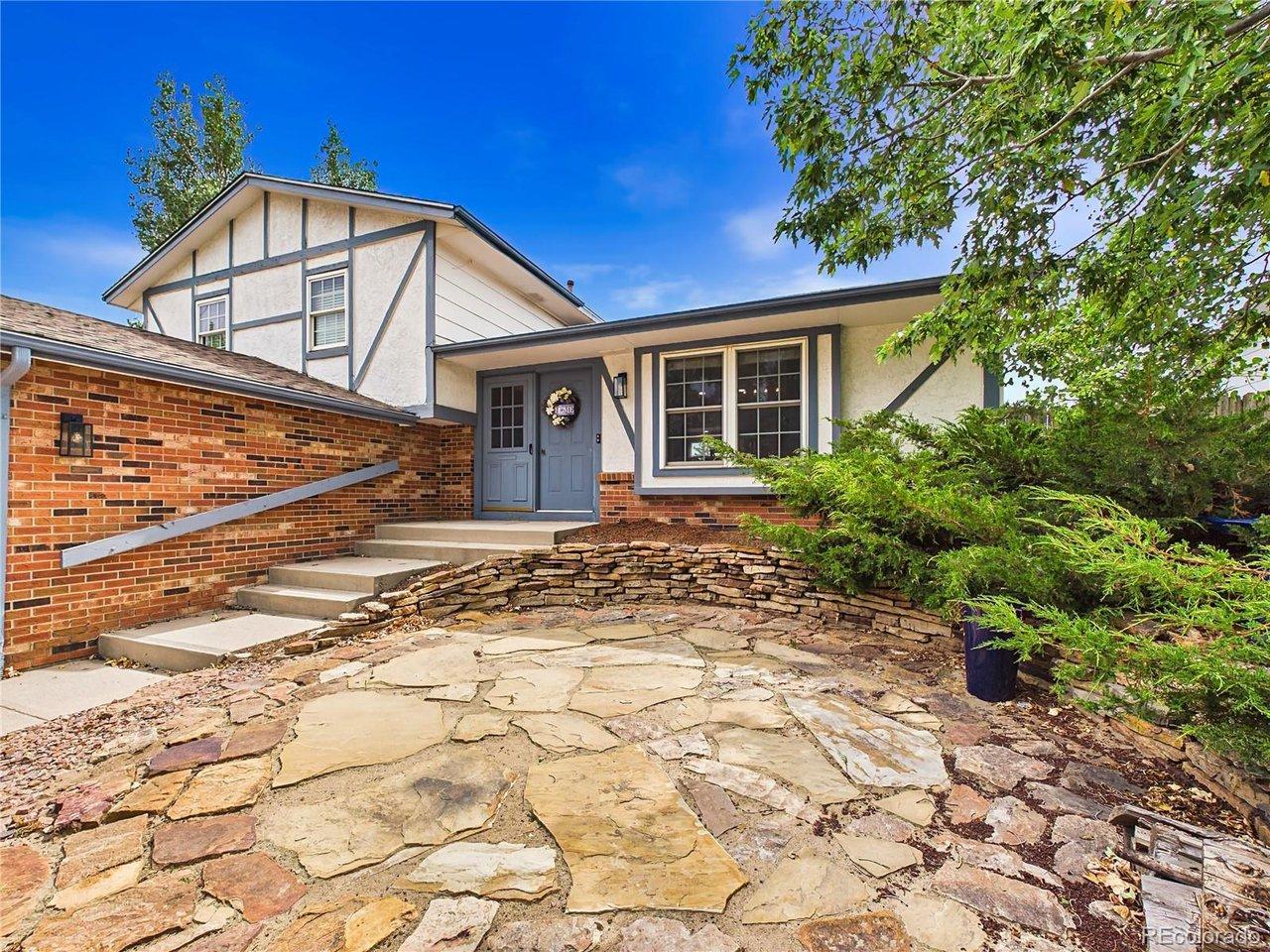 Image 3: Welcoming front entrance highlighted by a flagstone patio, attractive landscaping, and charming architectural details. Image 3: Welcoming front entrance highlighted by a flagstone patio, attractive landscaping, and charming architectural details.