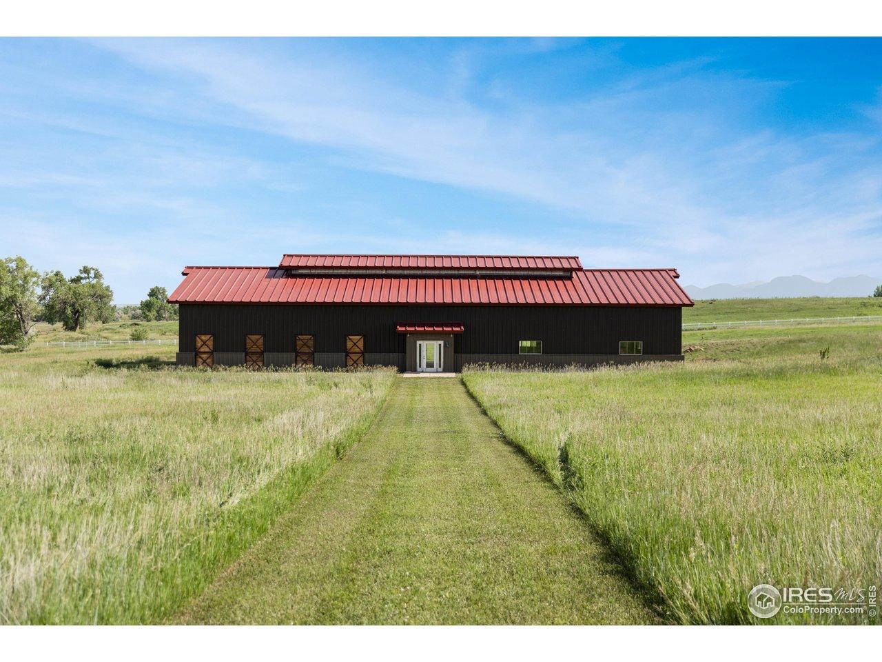 Image 3: Positioned at the edge of the property, the second barn is a blank slate with concrete flooring and soaring ceilings. Whether envisioned for future equestrian use, hobby storage, or large-scale workshops, the space is full of potential. Image 3: Positioned at the edge of the property, the second barn is a blank slate with concrete flooring and soaring ceilings. Whether envisioned for future equestrian use, hobby storage, or large-scale workshops, the space is full of potential.