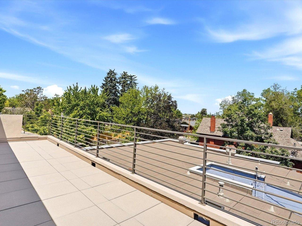 Image 4: Rooftop rail + panoramic mountain backdrop