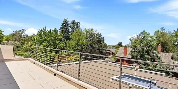 Image 4: Rooftop rail + panoramic mountain backdrop