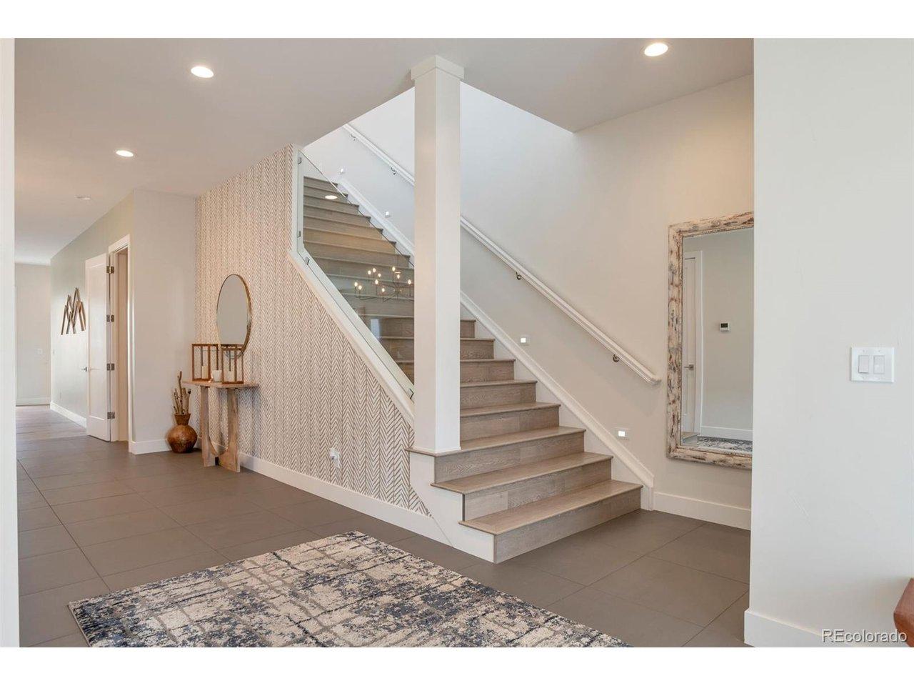 Image 2: Foyer entry with elegant wide lighted staircase Image 2: Foyer entry with elegant wide lighted staircase
