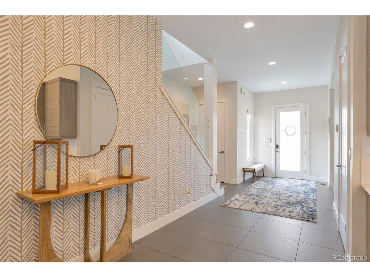 Image 3: Long entry foyer with view on the left of elegant wide staircase to upper level Image 3: Long entry foyer with view on the left of elegant wide staircase to upper level