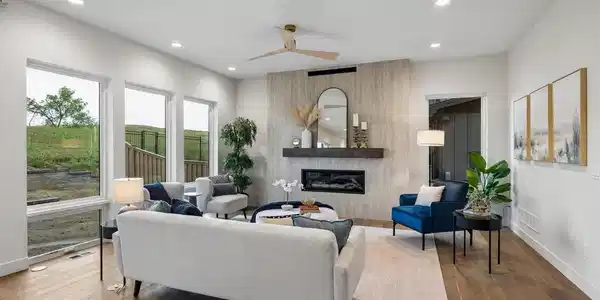 Image 4: Living room with fireplace and backyard views. Image 4: Living room with fireplace and backyard views.