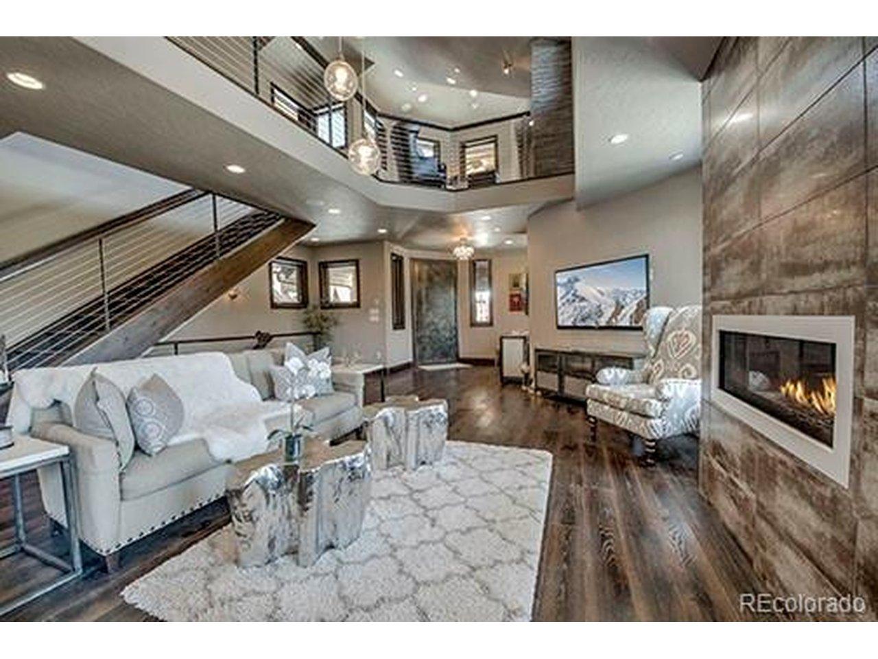 Image 4: Light-filled great room with soaring windows anddramatic ceilings.