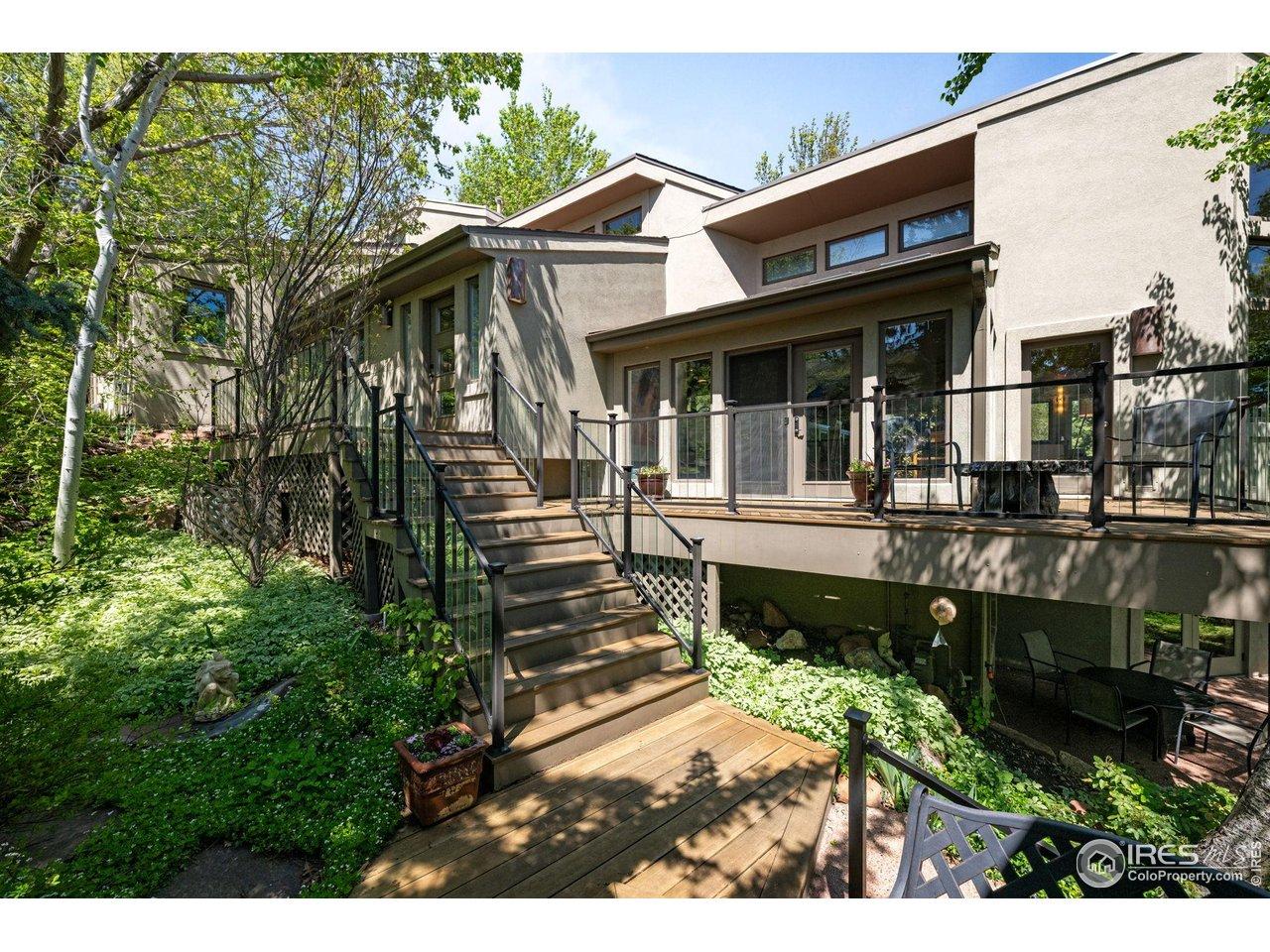 Image 3: A wood deck leads you to the front door surrounded by a maintained garden. Image 3: A wood deck leads you to the front door surrounded by a maintained garden.
