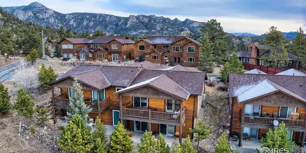 Image 2: Beautifully designed multi-level wooden townhome nestled against breathtaking mountain vistas. Featuring log siding, spacious decks, and mature landscaping with evergreen trees. Perfect mountain retreat with privacy and natural beauty. Image 2: Beautifully designed multi-level wooden townhome nestled against breathtaking mountain vistas. Featuring log siding, spacious decks, and mature landscaping with evergreen trees. Perfect mountain retreat with privacy and natural beauty.