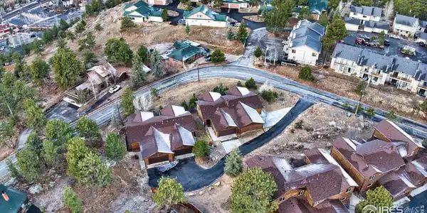 Image 3: Bird's eye view showcasing the thoughtful layout of these mountain townhomes with generous lot sizes, private outdoor spaces, and native landscaping. Just a few minutes walk into Downtown Estes Park. Image 3: Bird's eye view showcasing the thoughtful layout of these mountain townhomes with generous lot sizes, private outdoor spaces, and native landscaping. Just a few minutes walk into Downtown Estes Park.