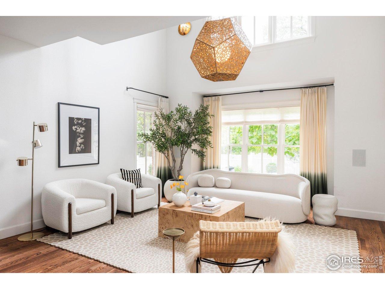 Image 4: The double-height living room is anchored by a gas fireplace and walls of glass leading outdoors. Image 4: The double-height living room is anchored by a gas fireplace and walls of glass leading outdoors.