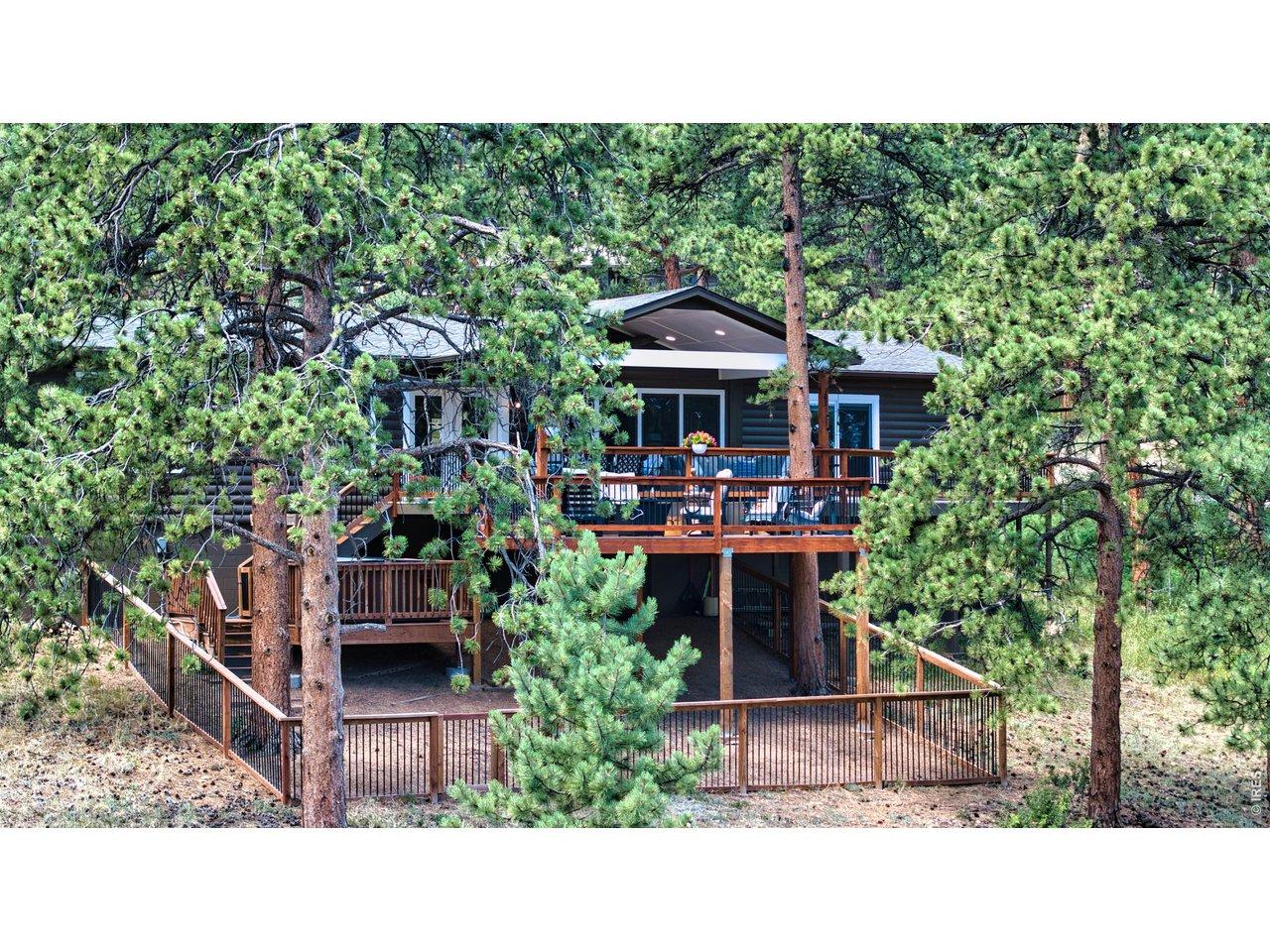 Image 2: Private mountain retreat highlighting outdoor entertainment areas, conversational seating areas, and a secure, fenced yard surrounded by mature ponderosa pine trees. Image 2: Private mountain retreat highlighting outdoor entertainment areas, conversational seating areas, and a secure, fenced yard surrounded by mature ponderosa pine trees.