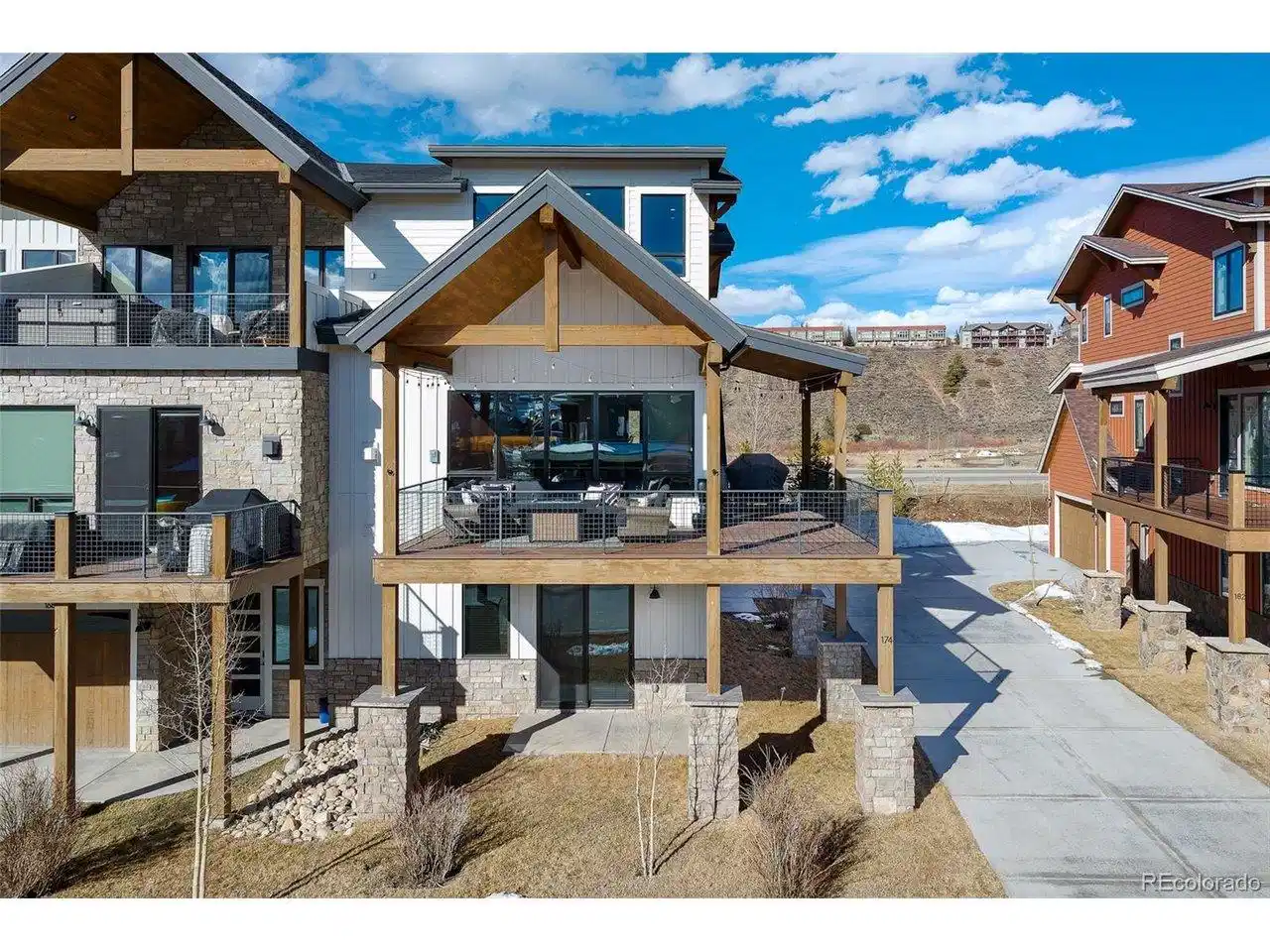 Image 1: he oversized covered deck lives like a second great room, with a fire table, generous seating, and space to gather year-round.