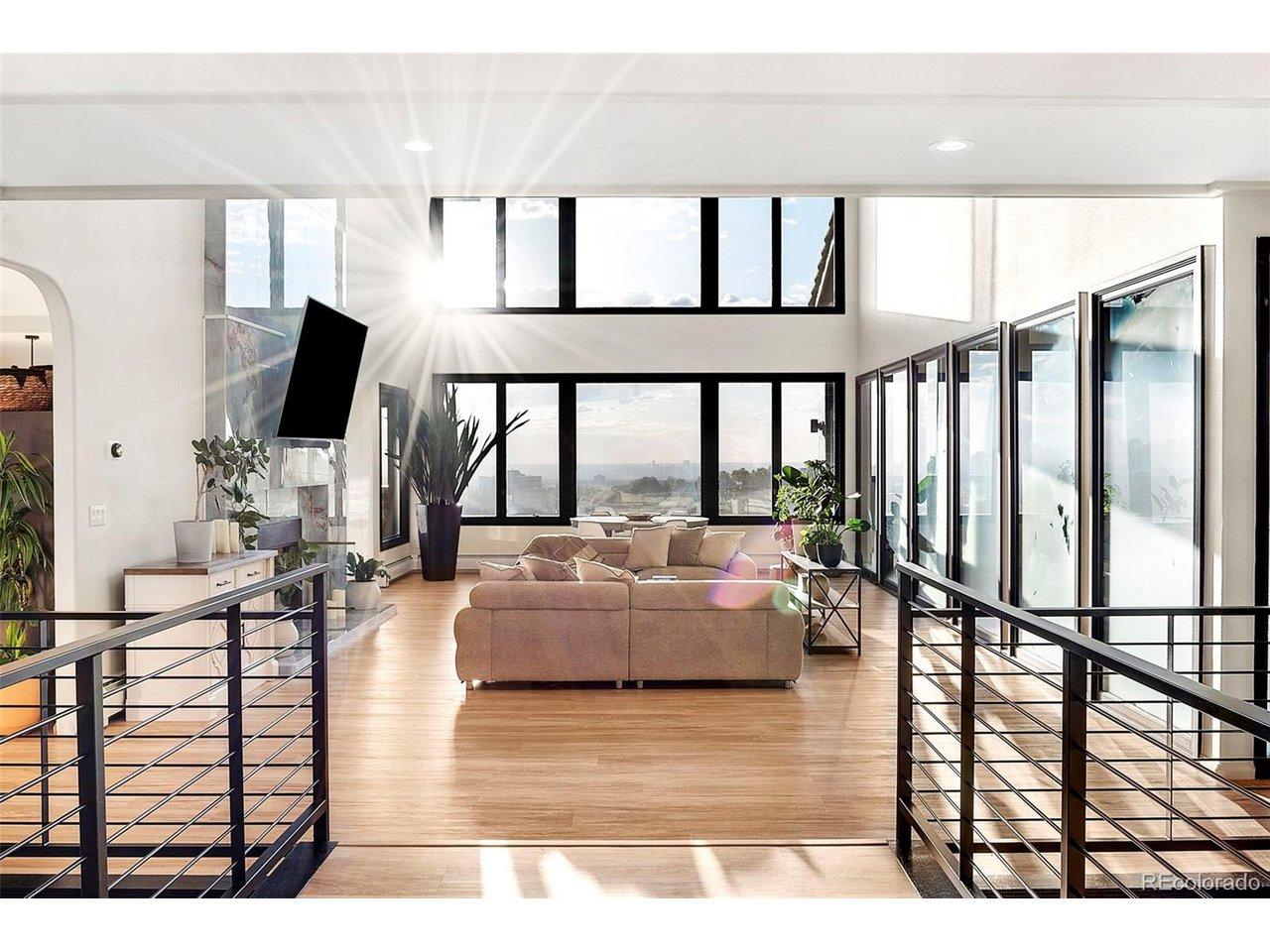 Image 4: From the expansive foyer the full vertical scale of the home comes into focus - the great room in front, the onyx fireplace wall at full height, the city beyond the glass. Image 4: From the expansive foyer the full vertical scale of the home comes into focus - the great room in front, the onyx fireplace wall at full height, the city beyond the glass.