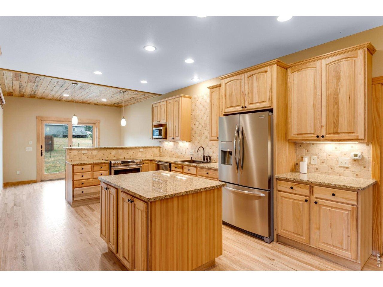 Image 2: Warm and inviting chef's kitchen complete with induction oven and granite counter tops. Image 2: Warm and inviting chef's kitchen complete with induction oven and granite counter tops.