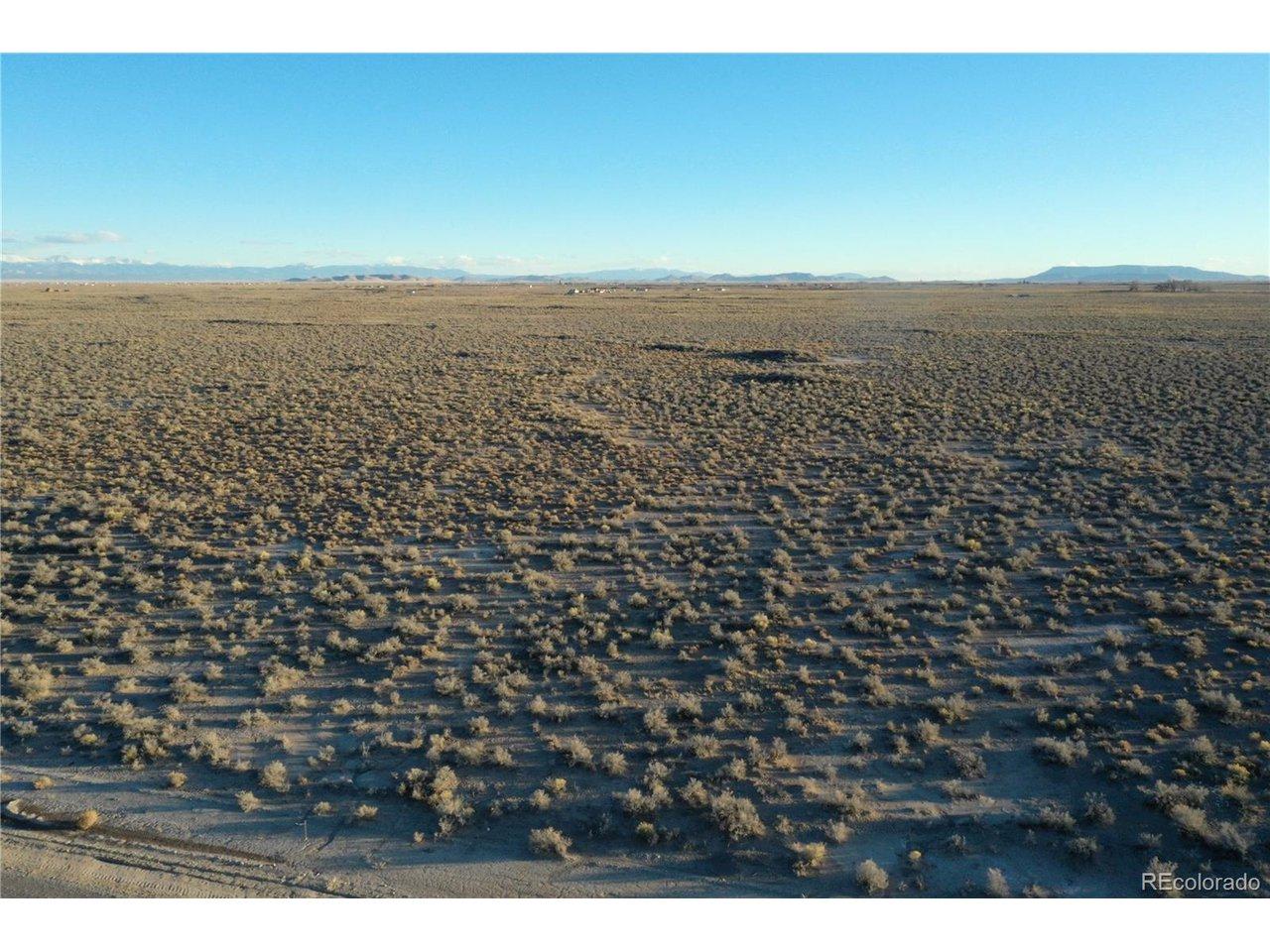 Image 4: Big view looking toward the west. The property in level with natural vegetation.