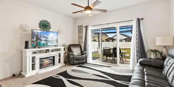 Image 4: Living Room filled with natural light and provides warm comfortable space for everyday living.