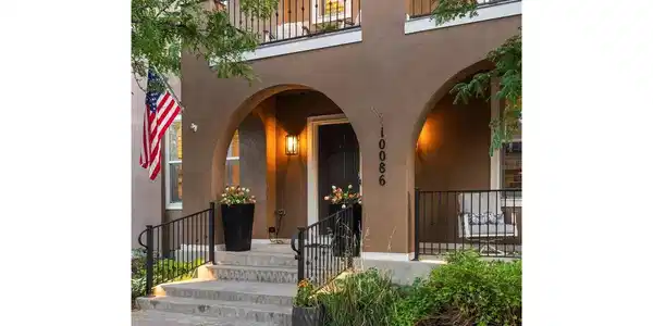 Image 2: An enchanting evening view highlights the home's graceful arches, upper balcony and welcoming front porch. Image 2: An enchanting evening view highlights the home's graceful arches, upper balcony and welcoming front porch.