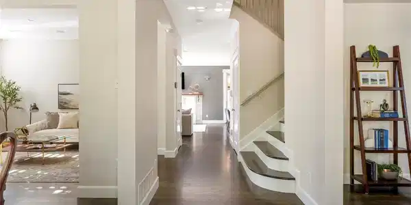Image 3: Rich hardwood floors and refined architectural details introduce the home's bright, flowing interior. Image 3: Rich hardwood floors and refined architectural details introduce the home's bright, flowing interior.