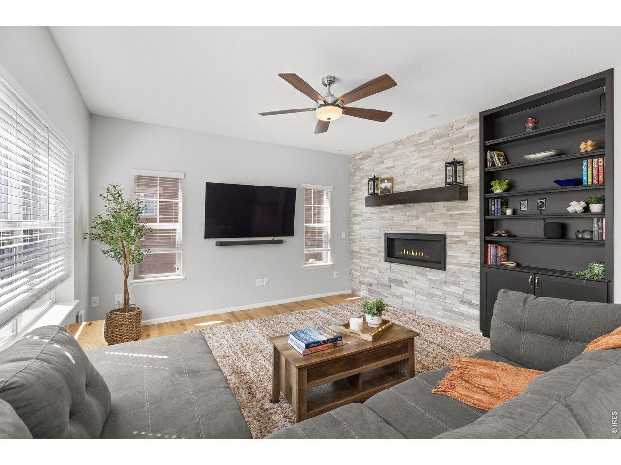 Image 3: Entertain in the inviting living room with gorgeous fireplace and built-in bookshelf with storage.