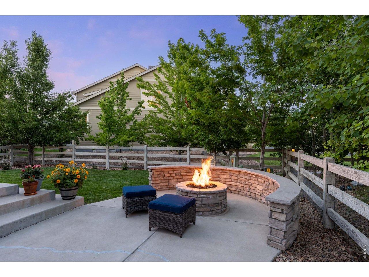 Image 4: The backyard is an entertainers dream with large patio, built in gas fireplace, mature landscaping, a pergola and plenty of space for grilling.