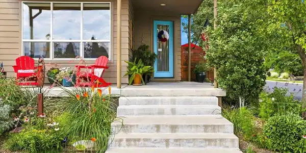 Image 3: A colorful front garden and covered porch offer an inviting place to relax and connect with the neighborhood. Image 3: A colorful front garden and covered porch offer an inviting place to relax and connect with the neighborhood.