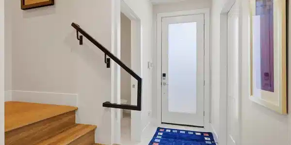 Image 4: The bright entry foyer features modern finishes, hardwood stairs and convenient access to the lower-level rooms.