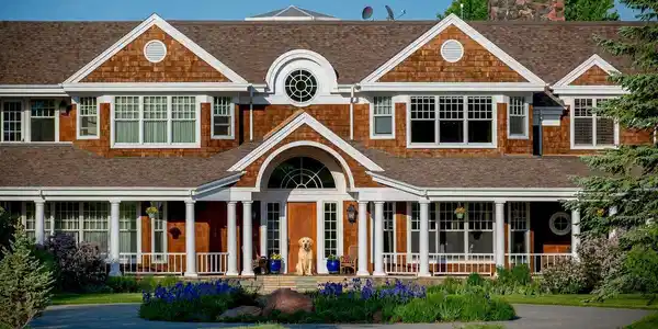 Image 4: You are welcomed to the home by your dog and a circular driveway, wrap-around covered verandas and a grand arch inspired by a sailboat. Image 4: You are welcomed to the home by your dog and a circular driveway, wrap-around covered verandas and a grand arch inspired by a sailboat.