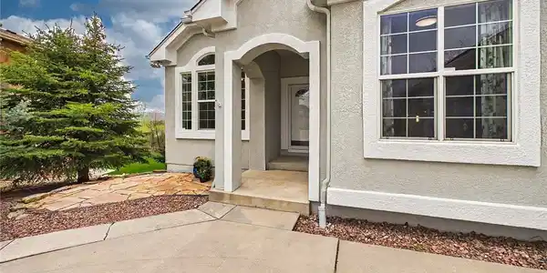 Image 2: Welcoming covered front porch featuring elegant arched architectural details, charming stone walkways, and a patio that leads to the spacious backyard. Image 2: Welcoming covered front porch featuring elegant arched architectural details, charming stone walkways, and a patio that leads to the spacious backyard.