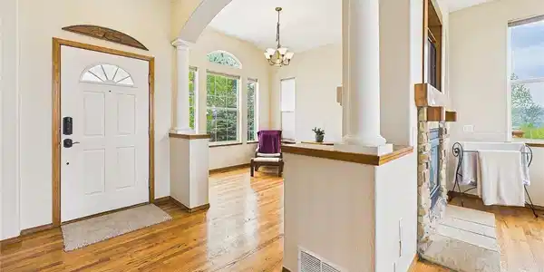 Image 3: Bright and inviting entryway with warm hardwood flooring, elegant columns, and open sightlines into the main living spaces. Image 3: Bright and inviting entryway with warm hardwood flooring, elegant columns, and open sightlines into the main living spaces.