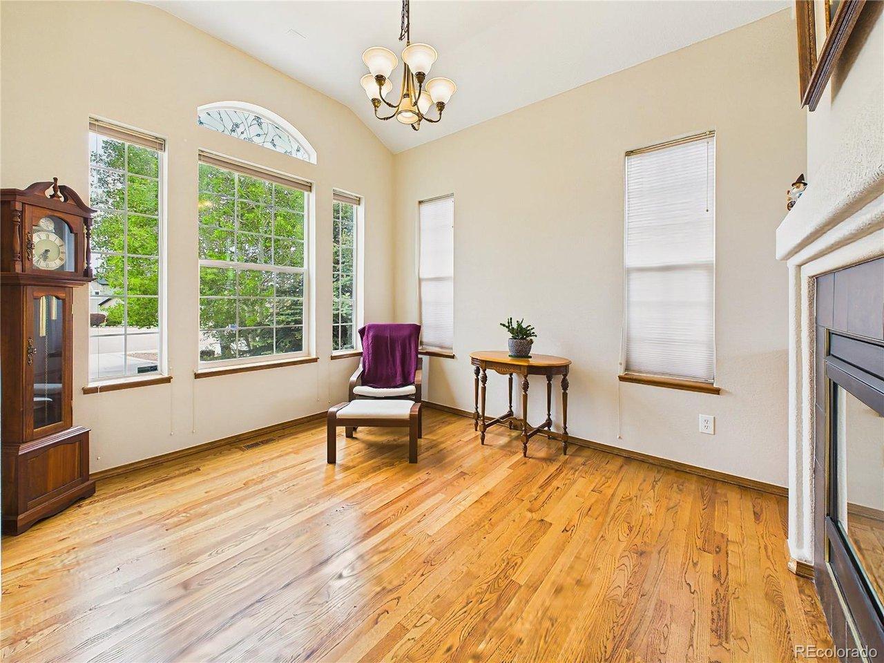 Image 4: Sunlit sitting area could be formal dining featuring vaulted ceilings, oversized windows, and beautiful hardwood floors for a warm and airy feel. Image 4: Sunlit sitting area could be formal dining featuring vaulted ceilings, oversized windows, and beautiful hardwood floors for a warm and airy feel.