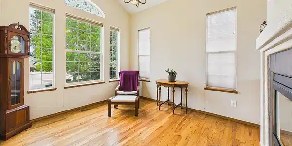 Image 4: Sunlit sitting area could be formal dining featuring vaulted ceilings, oversized windows, and beautiful hardwood floors for a warm and airy feel. Image 4: Sunlit sitting area could be formal dining featuring vaulted ceilings, oversized windows, and beautiful hardwood floors for a warm and airy feel.