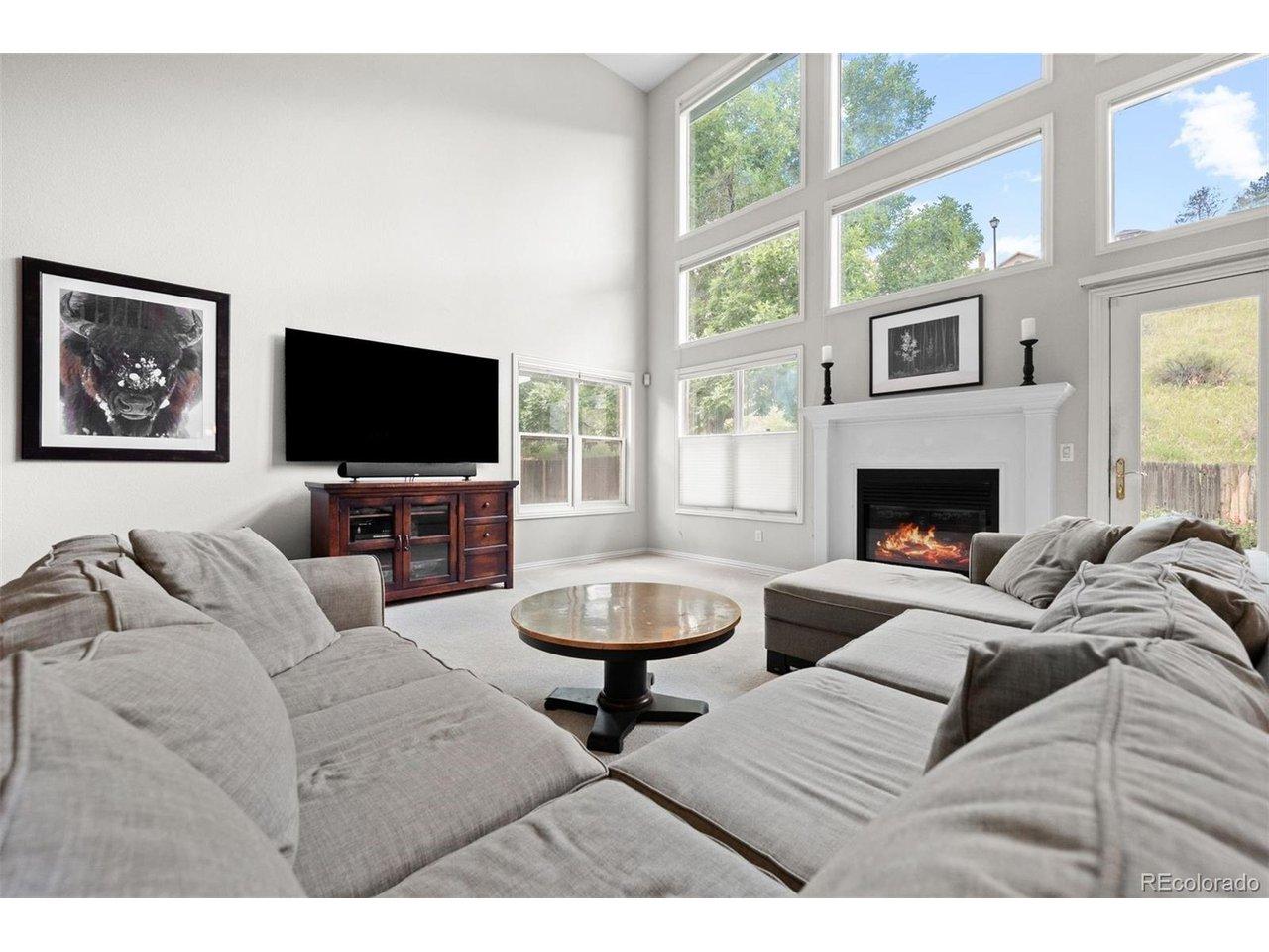 Image 3: Sun-drenched great room showcasing wide windows and an open, airy feel