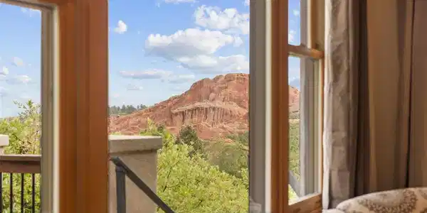 Image 4: Even from inside, the scenery takes center stage, with oversized windows capturing beautiful red-rock views from another level of the home.