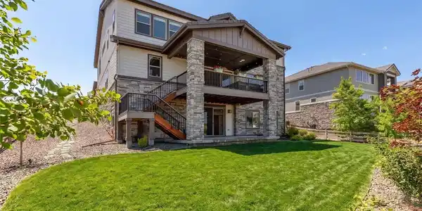 Image 4: Large lot and covered back patio and deck with views of the front range (lawn enhanced)