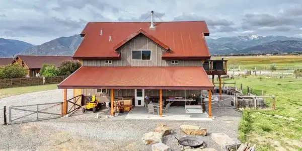 Image 4: The north side of the home, with covered patio and fire pit area. Image 4: The north side of the home, with covered patio and fire pit area.