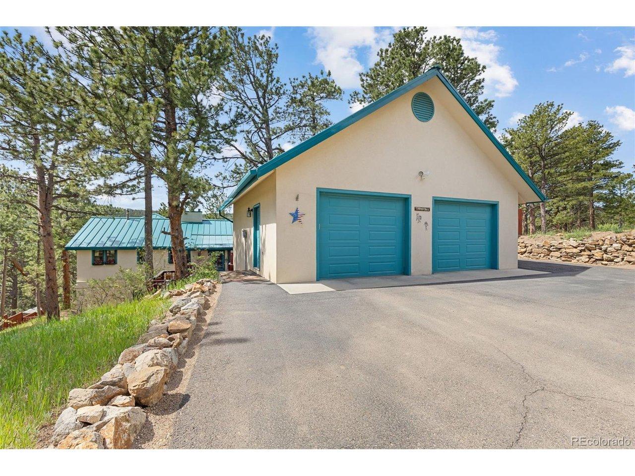 Image 2: 870 SF detached garage (2006) with easily accessed attic storage + an asphalt driveway Image 2: 870 SF detached garage (2006) with easily accessed attic storage + an asphalt driveway