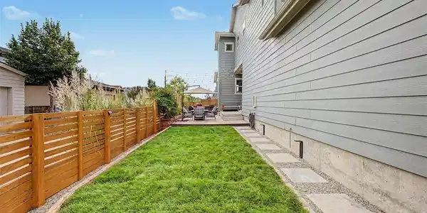 Image 3: Preview of backyard with fresh sod: Pathway leading to backyard patio and outdoor kitchen Image 3: Preview of backyard with fresh sod: Pathway leading to backyard patio and outdoor kitchen